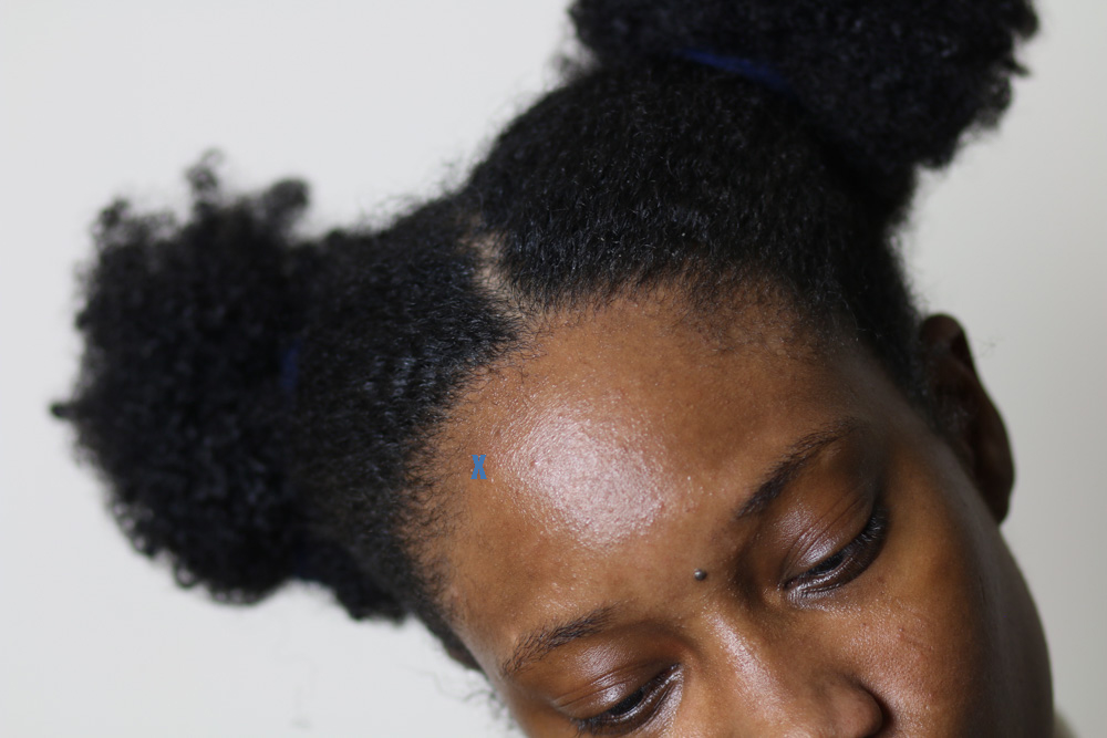 A close-up picture of Shanté with her hair in two puffs.