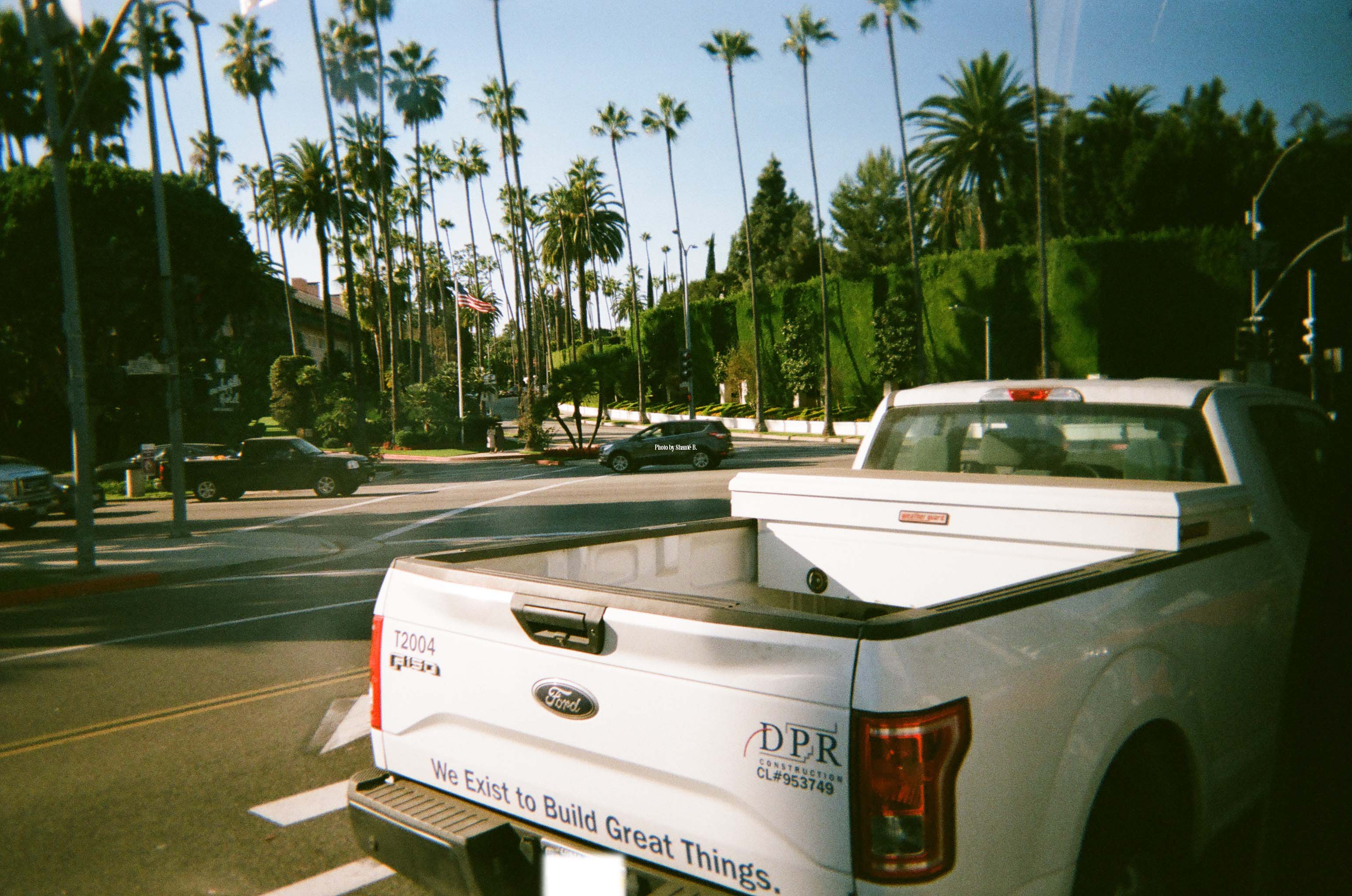 A picture of a truck and palm trees.