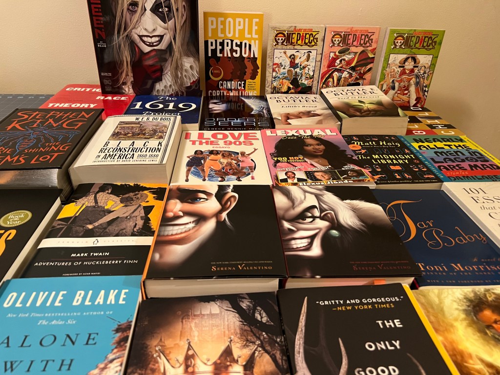 Multiple book spread out on a table.